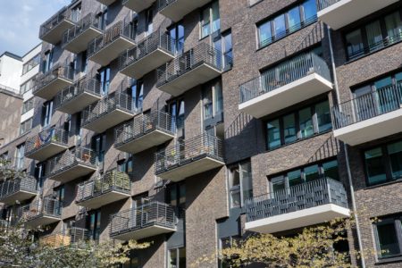 modern gray apartment building with many balconies