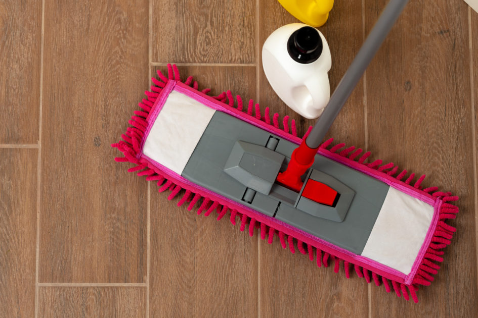 Microfiber mop and cleaning solution on tile floor for streak-free mopping
